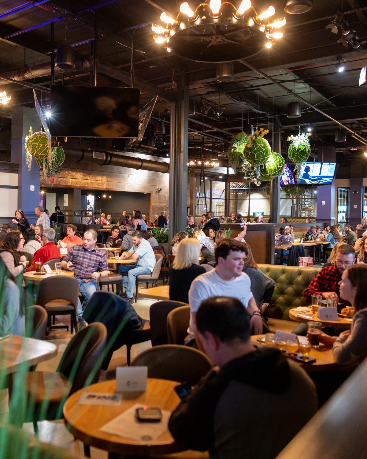 Guests filling the dining room at Elicit Brewing in Fairfield — a restaurant and brewery built by REI Hospitality