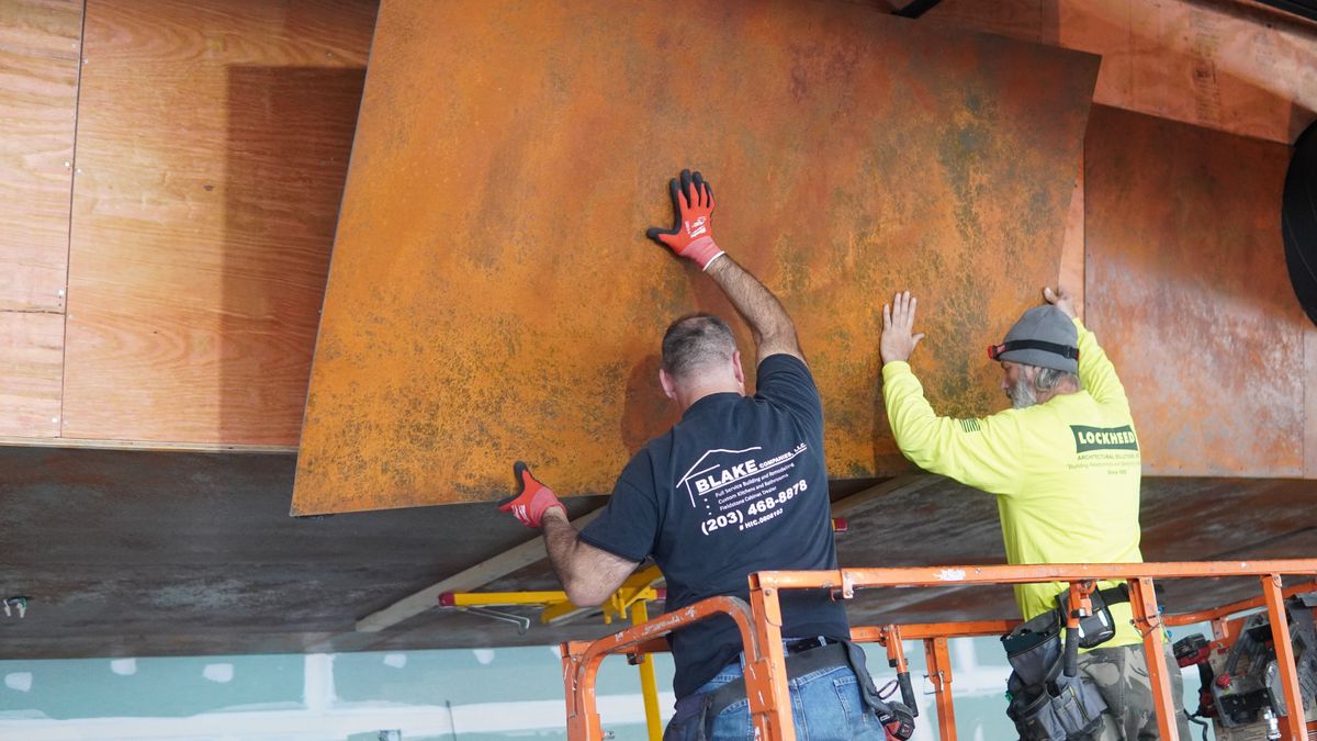 Build-out in progress — installing the brewhouse cladding at Elicit Brewing
